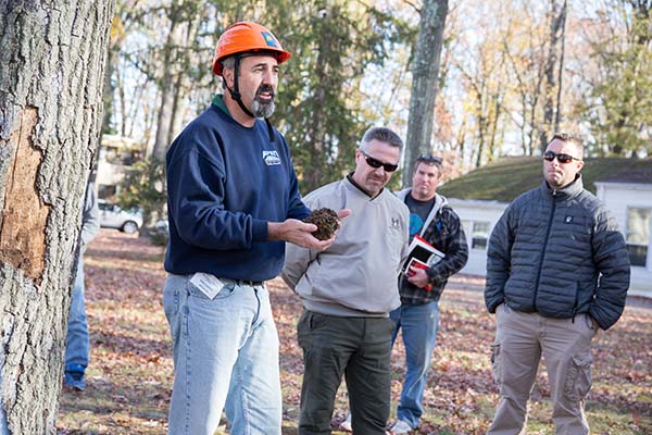 Hazardous Tree Identification instructor Steve Chisholm holds a handful of soil