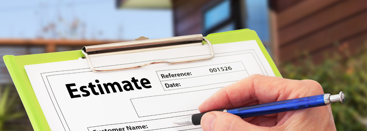 Image of a clipboard with an estimate document on it and a person about to write on the document with a landscaped yard in the background.