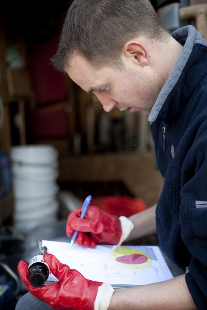 Man analyzing water samples and writing report