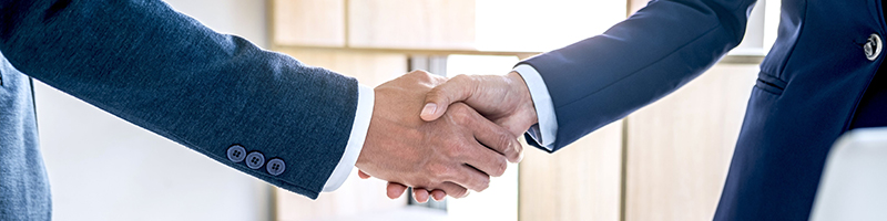 Handshake between two men in business suits