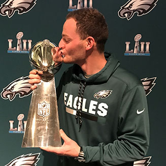 Rutgers Turf alumnis Conor Geisel kissing the Vince Lombardi trophy after the 2018 Super Bowl