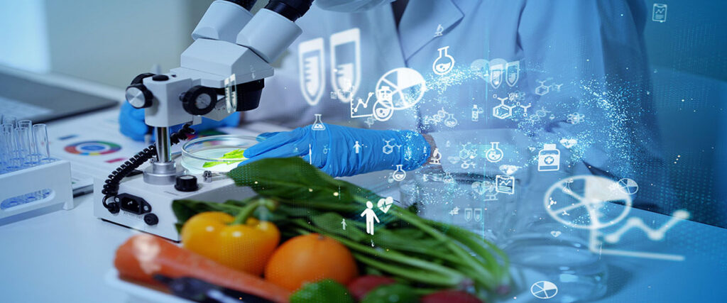 Close up of food scientist analyzing sample under micrscope with food items in foreground