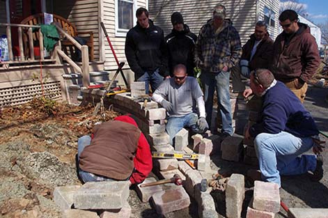 Students complete a hands-on concrete paver project on the Rutgers campus.