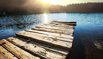 Lake with dock at sunset