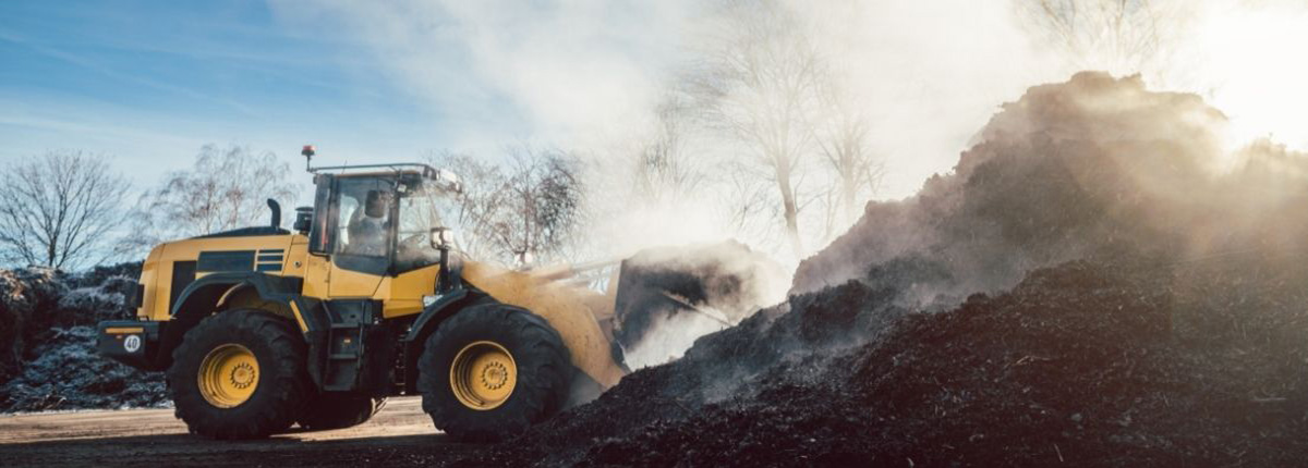 Bulldozer scooping up compost