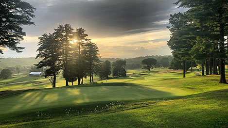 Sun breaking through clouds over Neshobe Golf Club in Brandon, VT