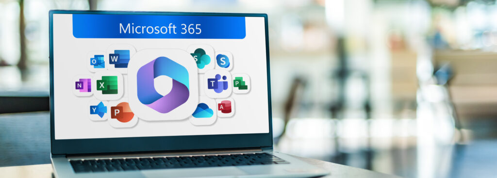 Laptop on table; screen displaying Microsoft 365 app icons