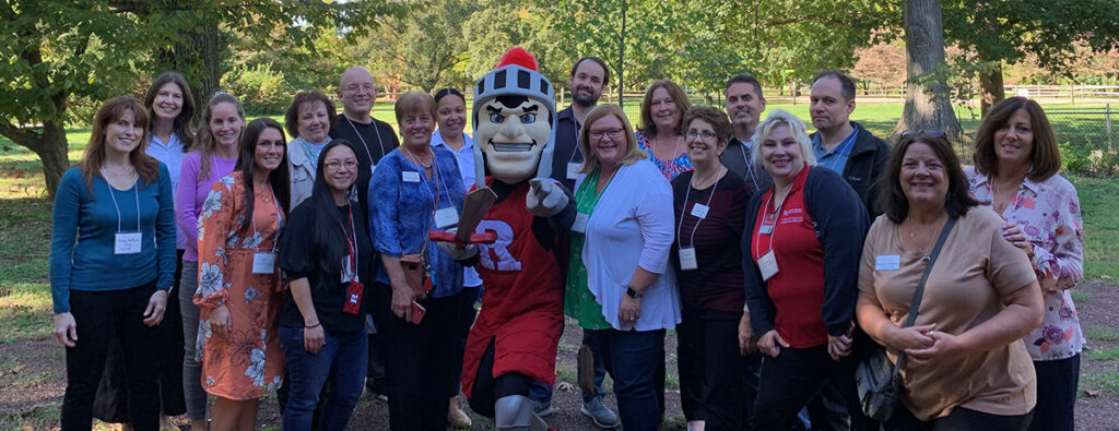 OCPE Staff Members pose with the Scarlet Knight