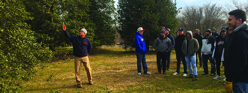 Bruce Neary demonstrates pruning techniques to Turf students in the Rutgers Gardens