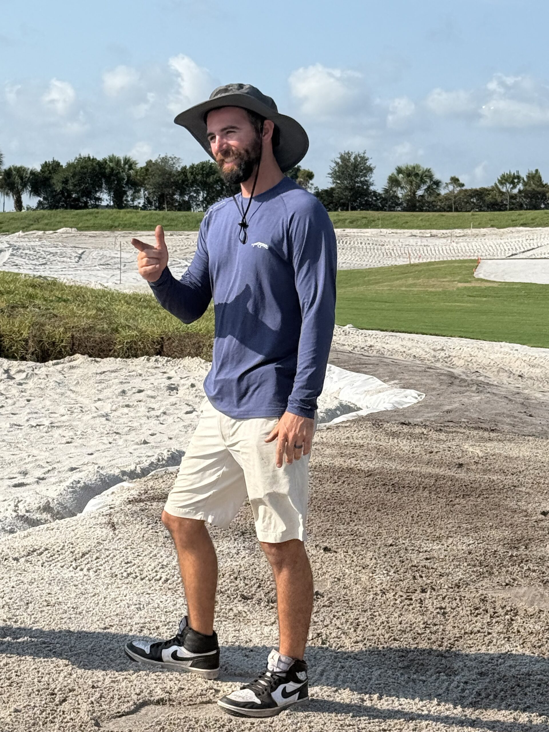 Photo of Tyler Robb, alumni of the Rutgers two-year turf management certificate program, working on the golf course at Grove XXIII in Florida, 2025