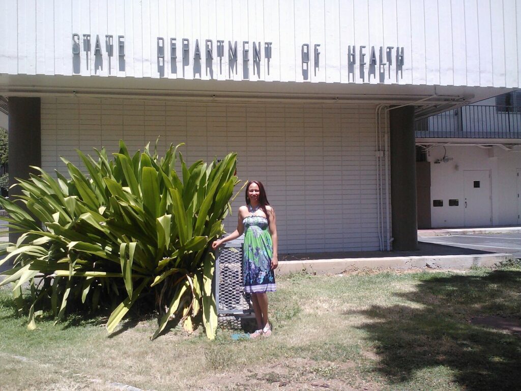 EPH graduate Ruchi Pancholy in front of the Hawaii Department of Health building.