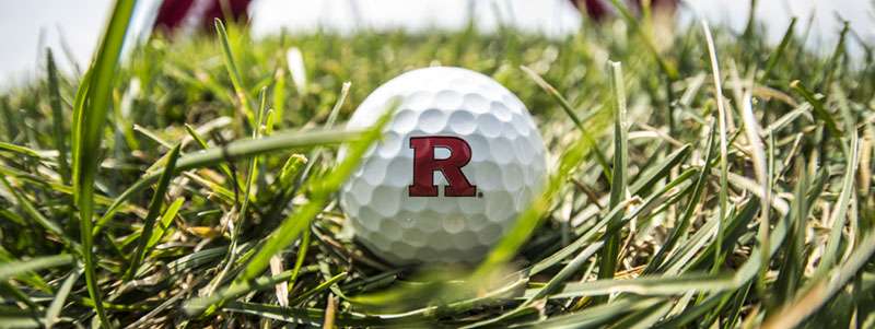 Golf ball with Rutgers 'R' logo on turfgrass