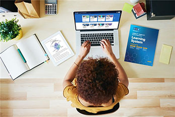 SHRM 2025 image showing student at laptop studying for SHRM exam