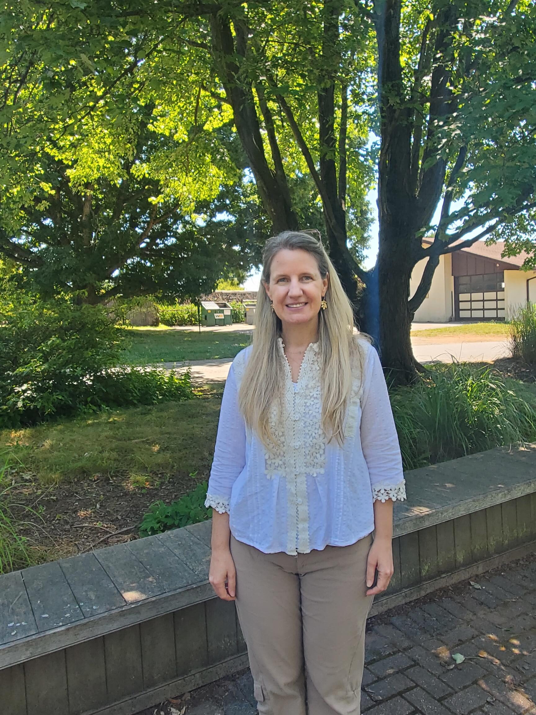 Instructor Virginia Wheatly standing in front of grassy area