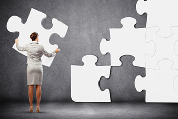 Problem solving concept of businesswoman trying to fit puzzle piece into puzzle