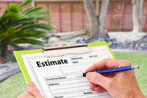 Clipboard holding Estimate sheet with landscaped garden in the background