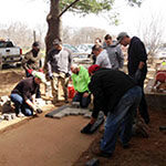 Students lay pavers in a new walkway