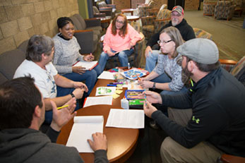 Students in the Improving Your Public Communication Skills class work together in groups to complete a hands-on activity