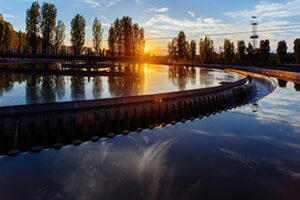 Modern industrial wastewater treatment plant at sunset