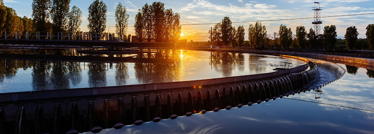 Modern industrial wastewater treatment plant at sunset