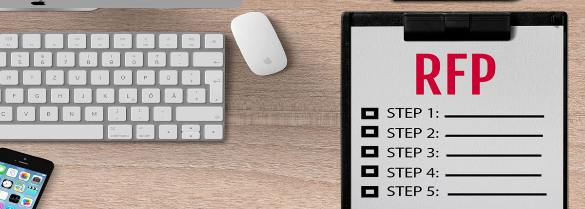 Clipboard with RFP steps on desk next to computer keyboard