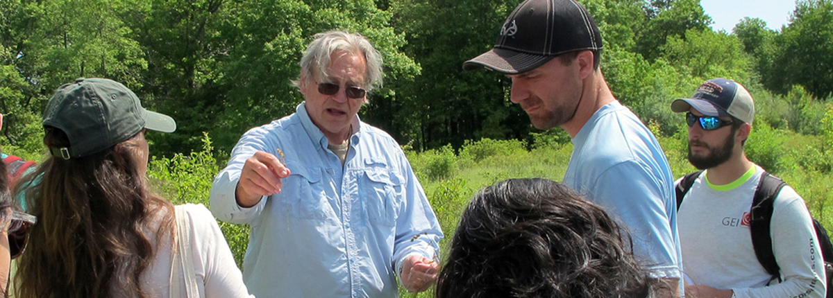 Wetlands course instructor Ralph Tiner showing students a wetland plant