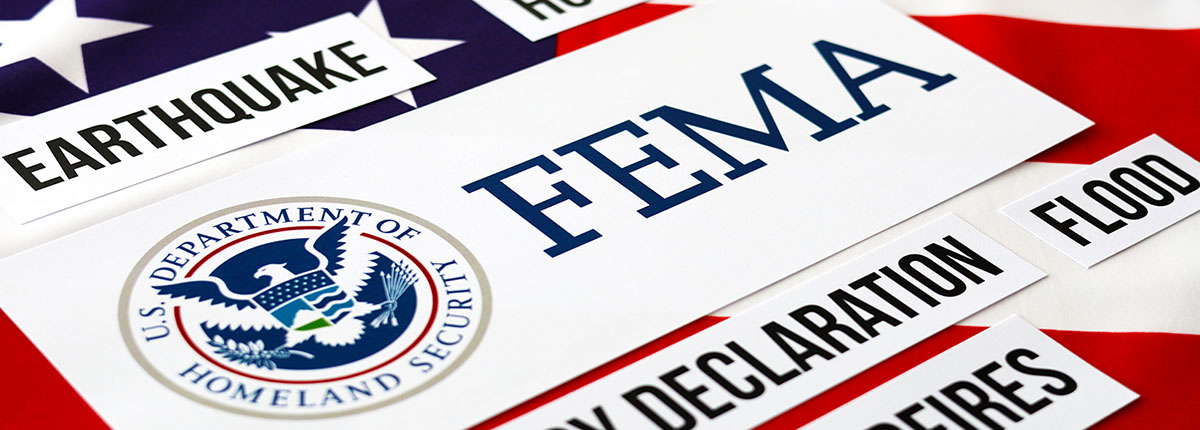 FEMA related words like earthquake and flood with over American flag background