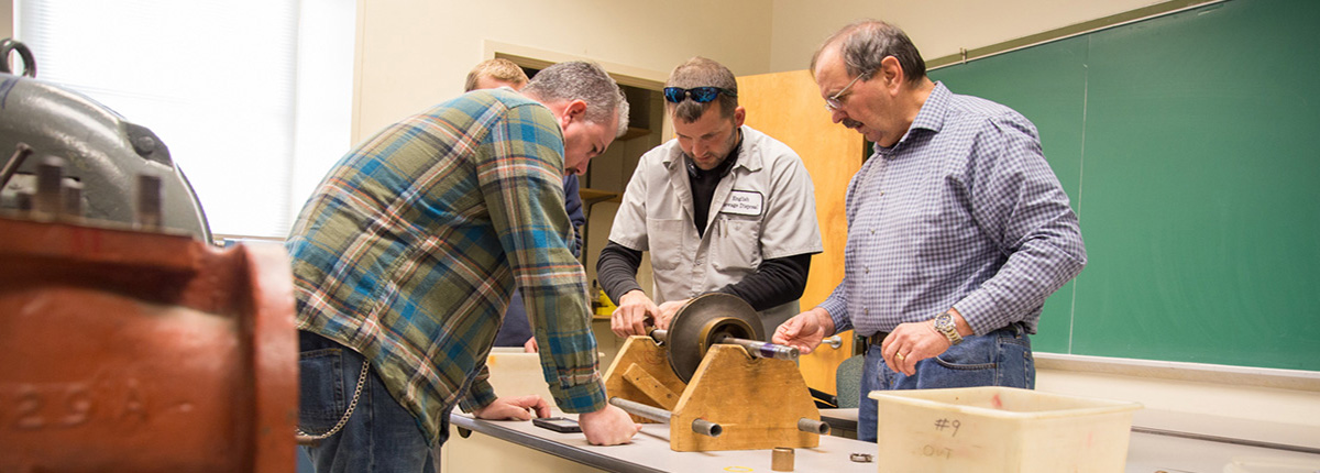 O & M of Pumps students participating in hands on pump maintenance exercises