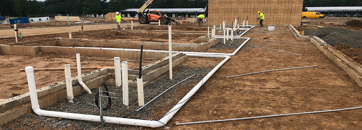 workers installing sub slab piping for vapor mitigation