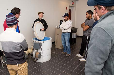 Instructor Bill Brodhead demonstrates components of radon mitigation systems during the Radon Mitigation course