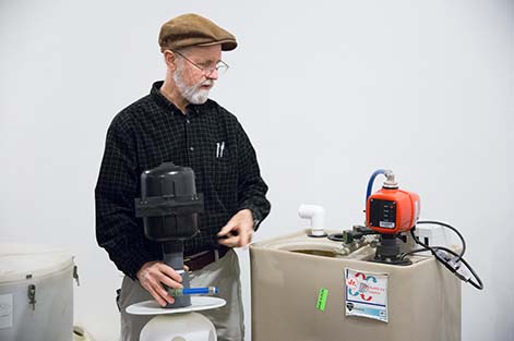 Bill Brodhead performs a demonstration with a radon mitigation system