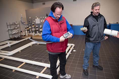Radon mitigation students participate in hands-on activities at the training slab