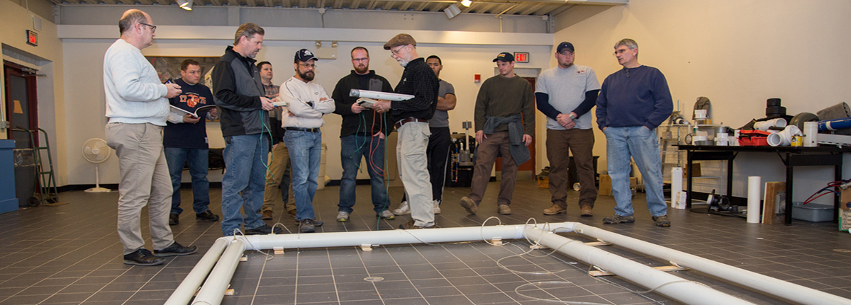 Radon mitigation course instructor Bill Brodhead teaching students in the radon mitigation training slab