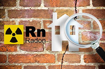 Image representing the danger of radon gas in homes with periodic table of the elements, radioactive warning symbol, and home silhouette seen through a magnifying glass