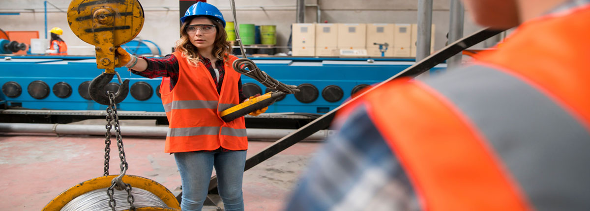 Female crane operator checks load