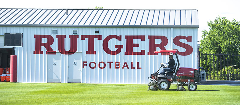 Sports turf manager mows practice fields for Rutgers football team