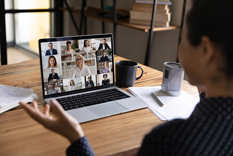 Woman participating in virtual online professional development training with colleagues on her laptop